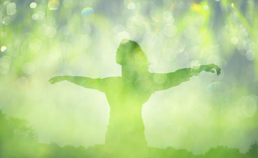 woman behind green leaves